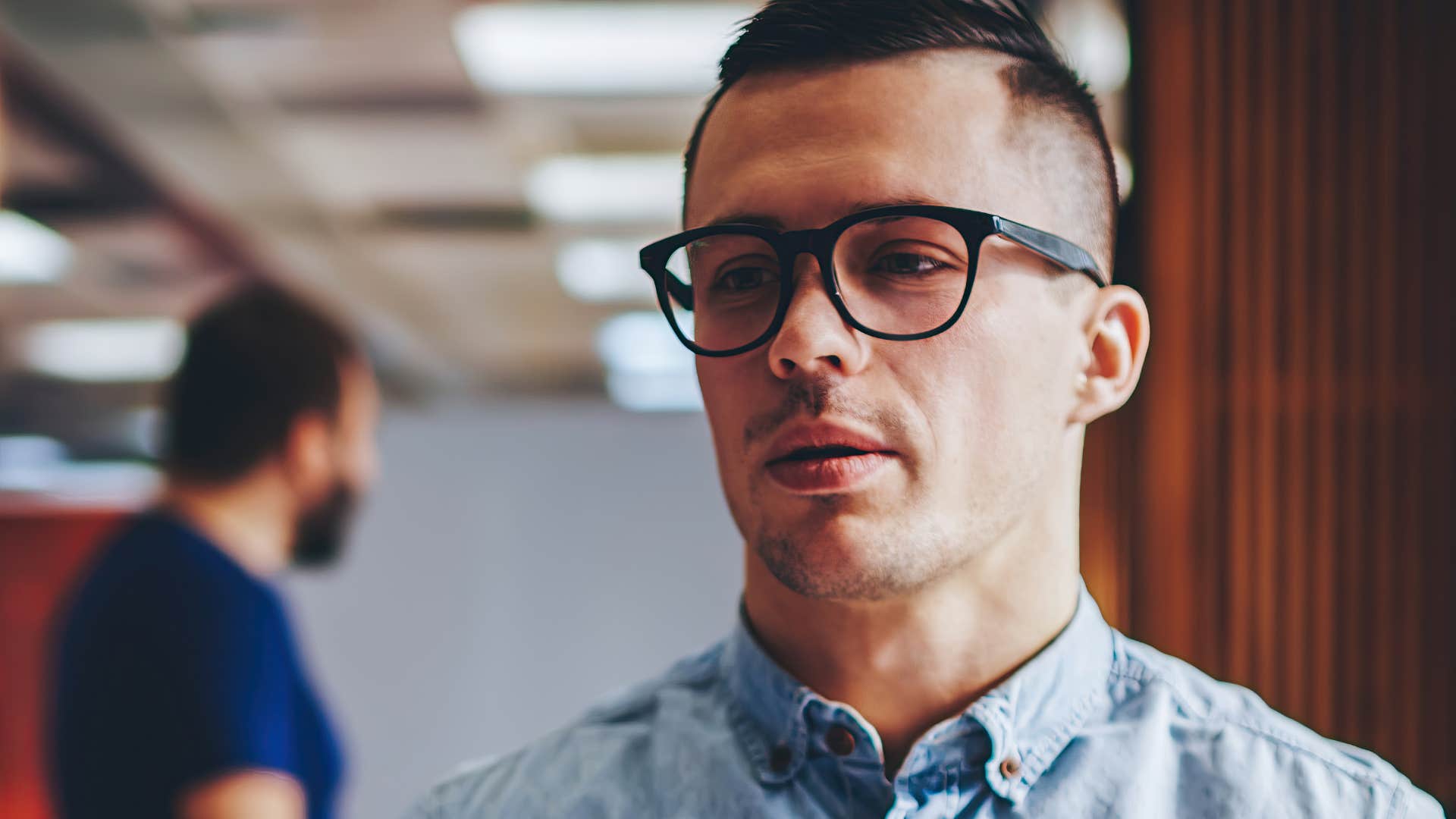man being protective of his personal space at work