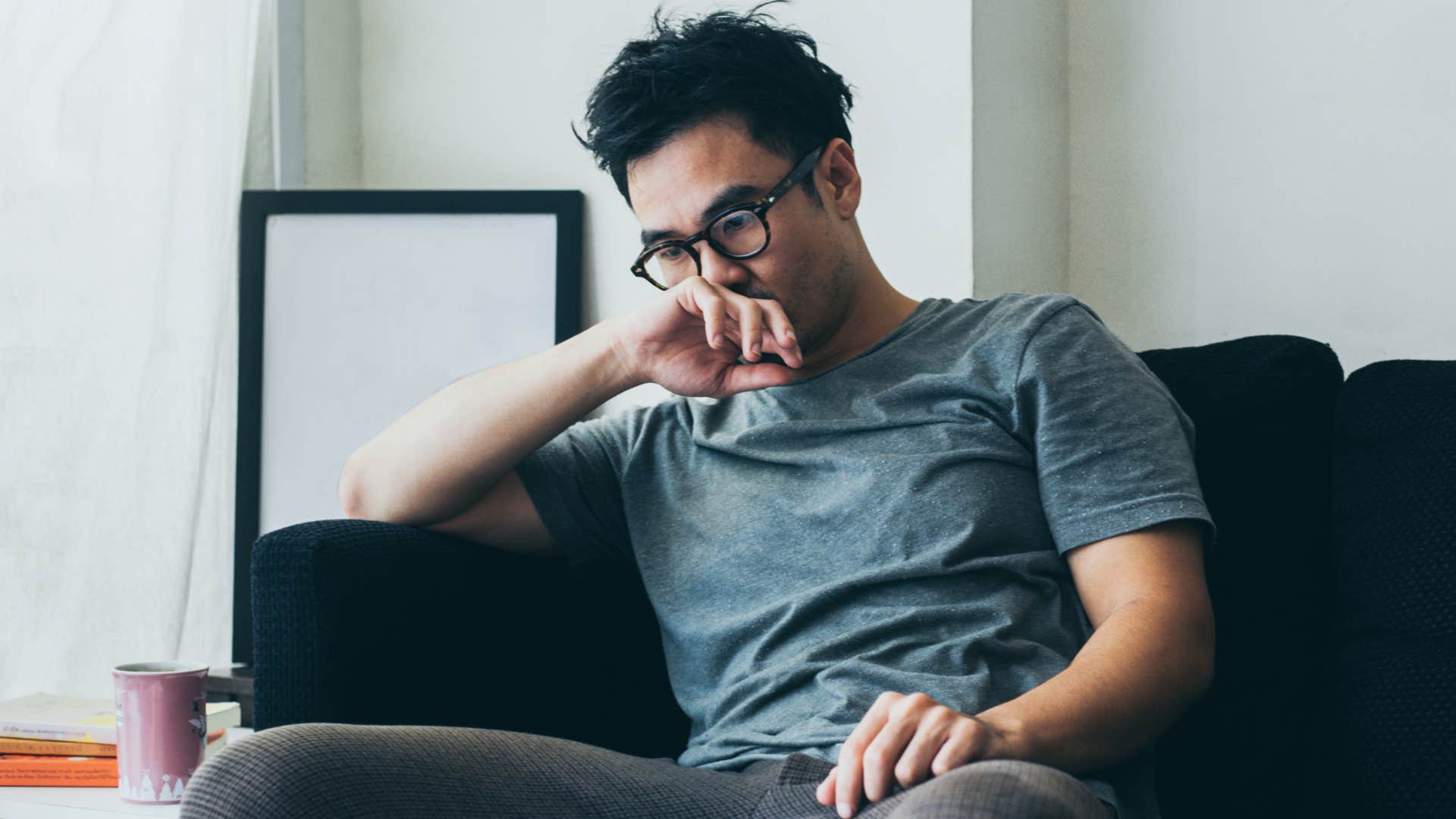 sensitive man sitting at home thinking