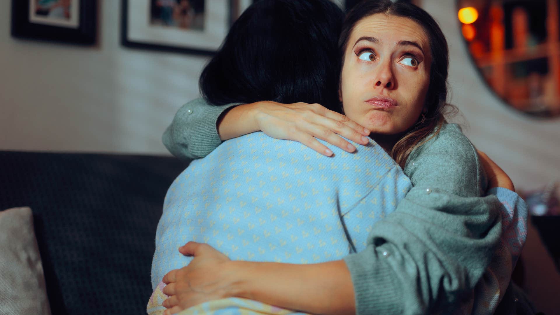 woman performing in social settings while hugging friend