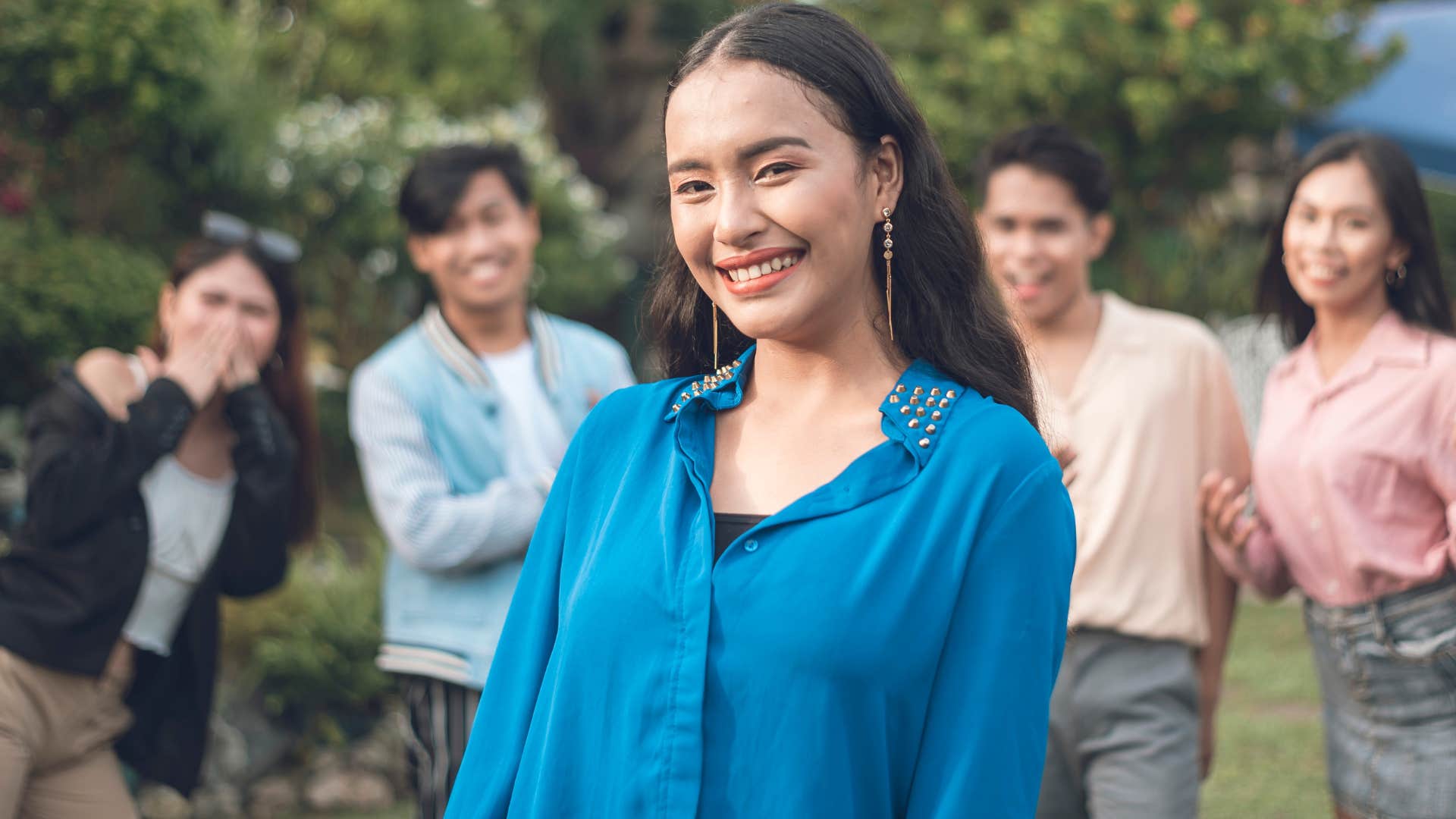 popular young woman smiling with friends