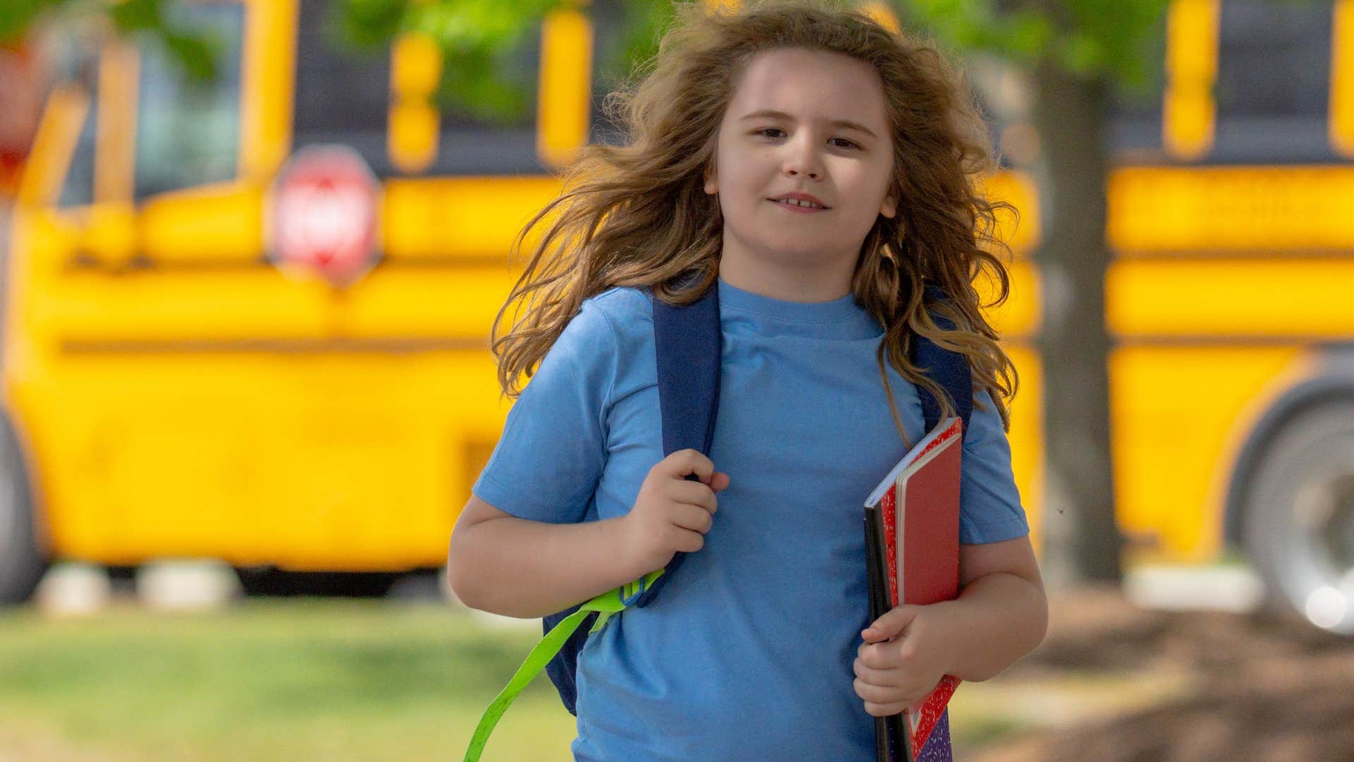 little boy walking to school alone smiling