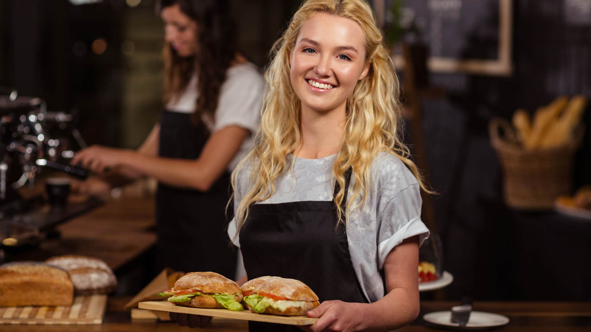 service worker holding food thinking quickly on her feet
