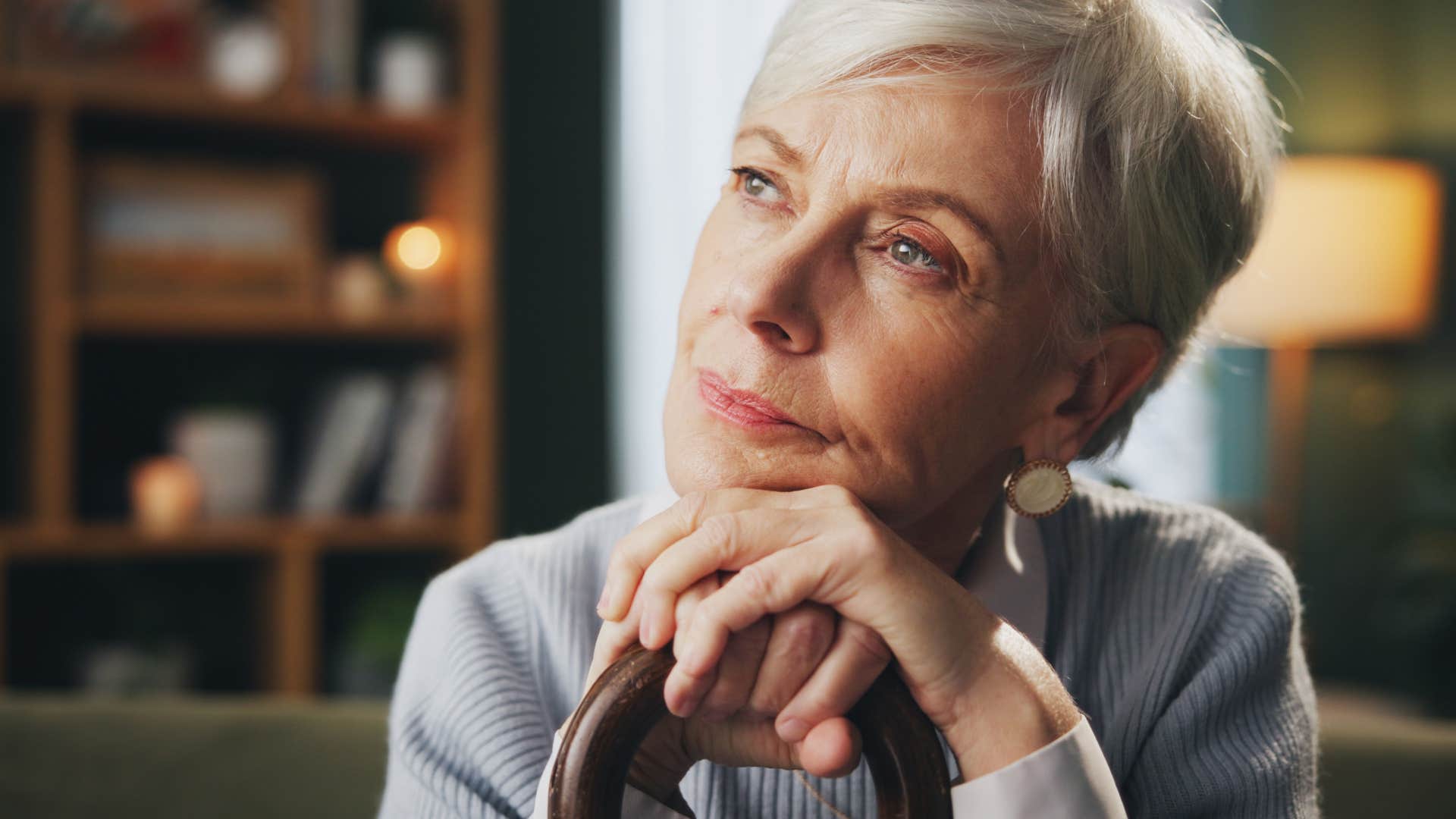 introspective person rests chin on hands showing willpower to resist temptation