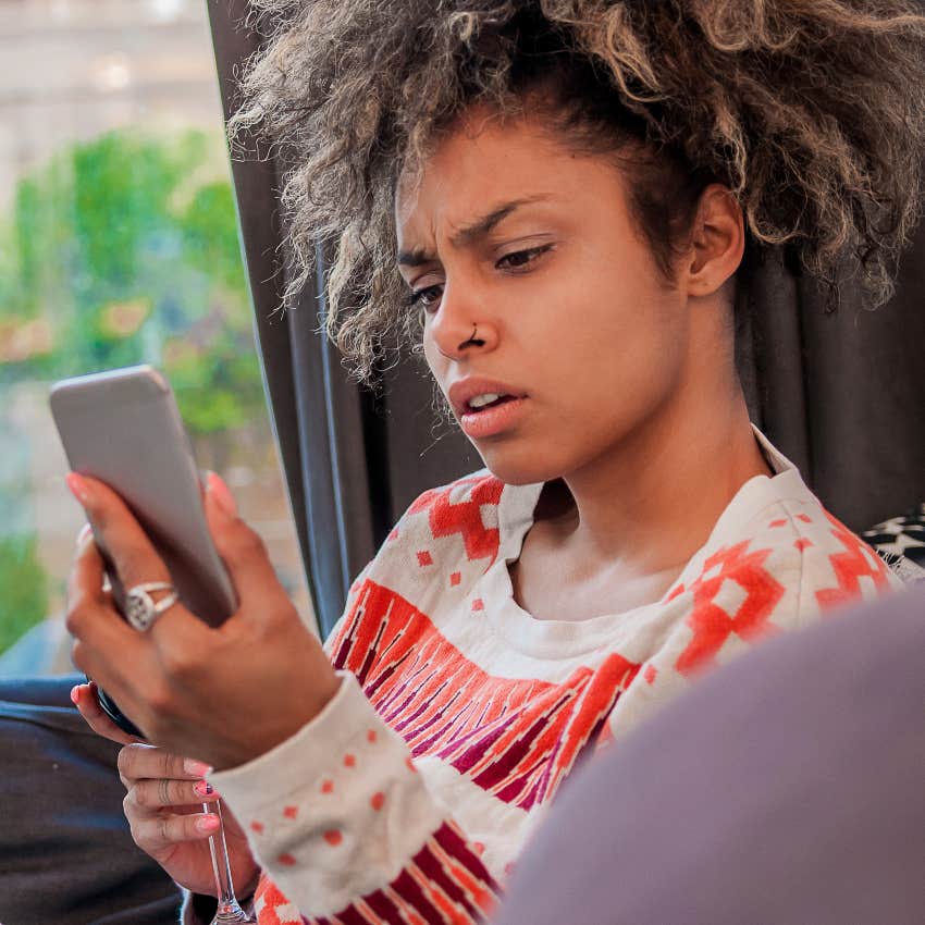 woman checking phone after feeling notification