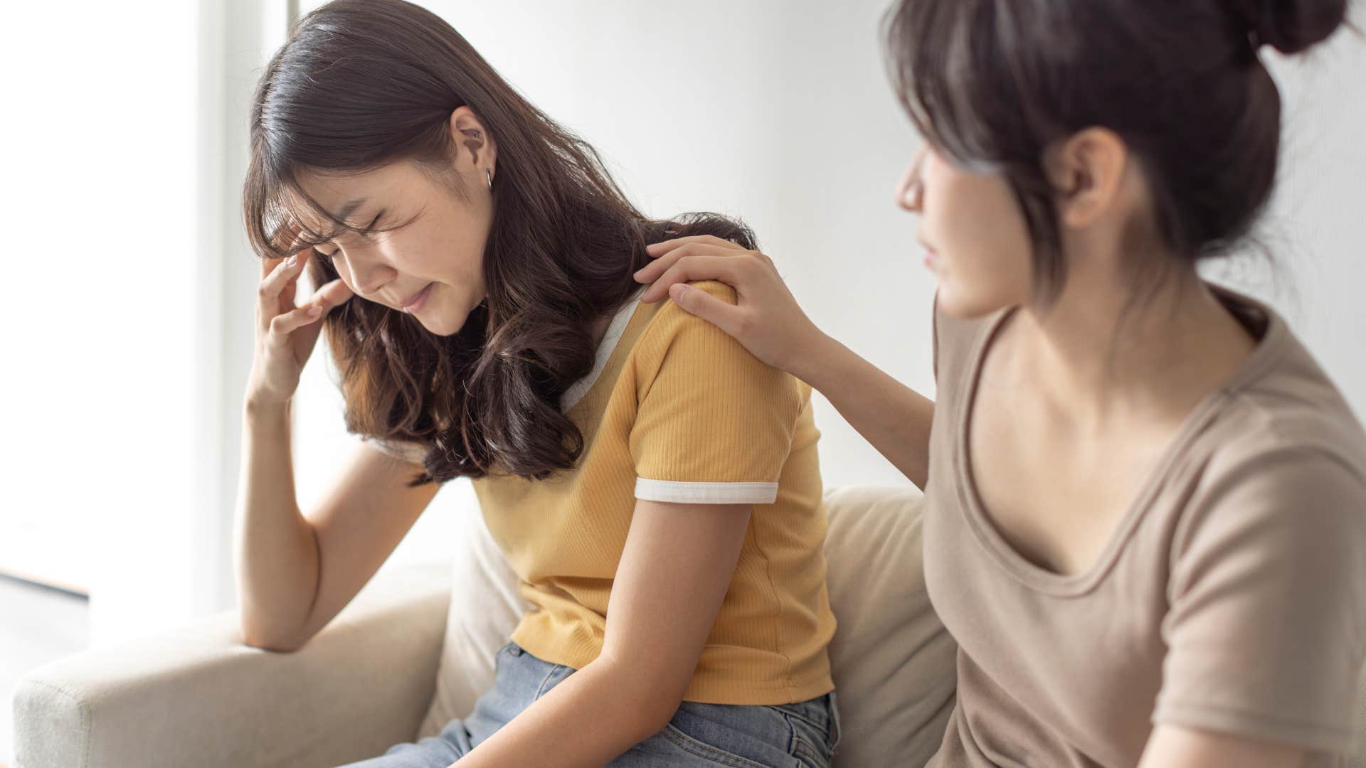 Woman saying "I'm just unlucky" to her comforting friend.
