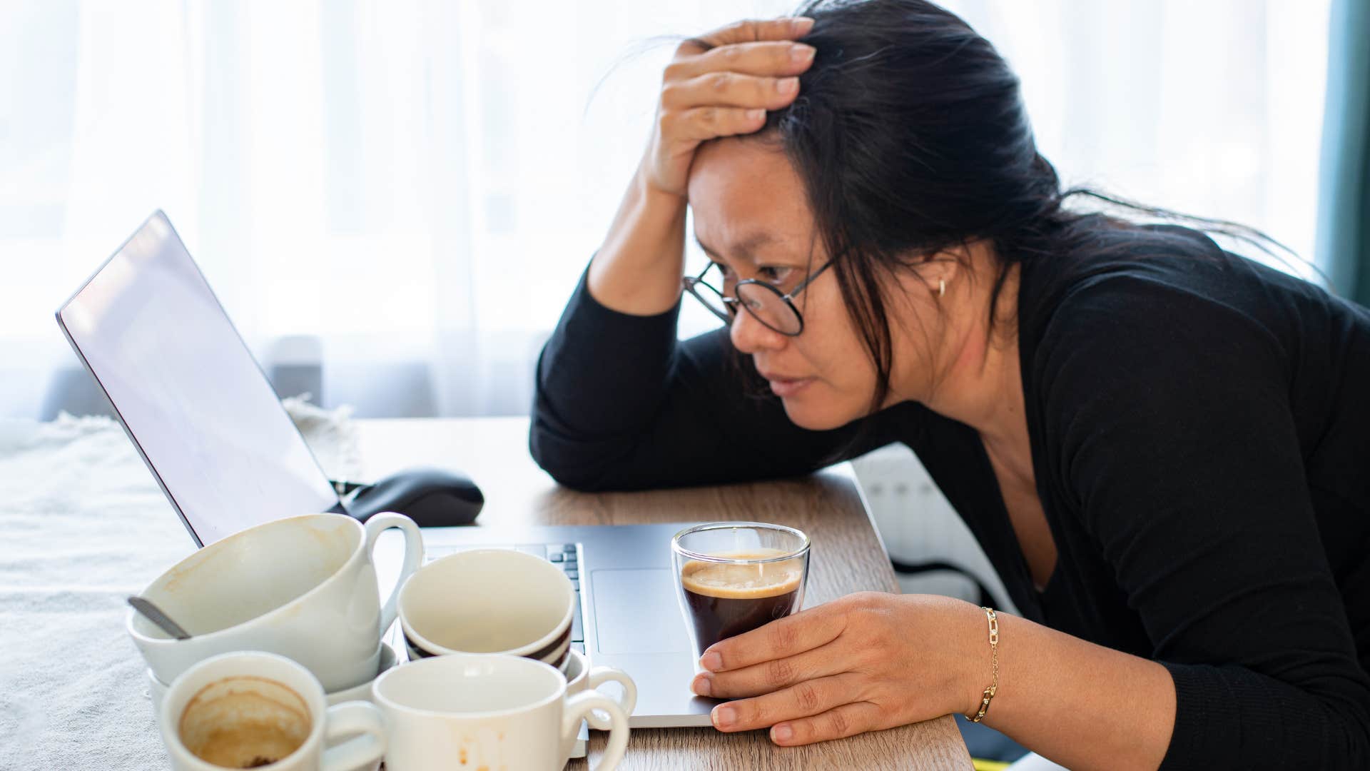 Woman saying "my life is a mess" while working in a messy room.