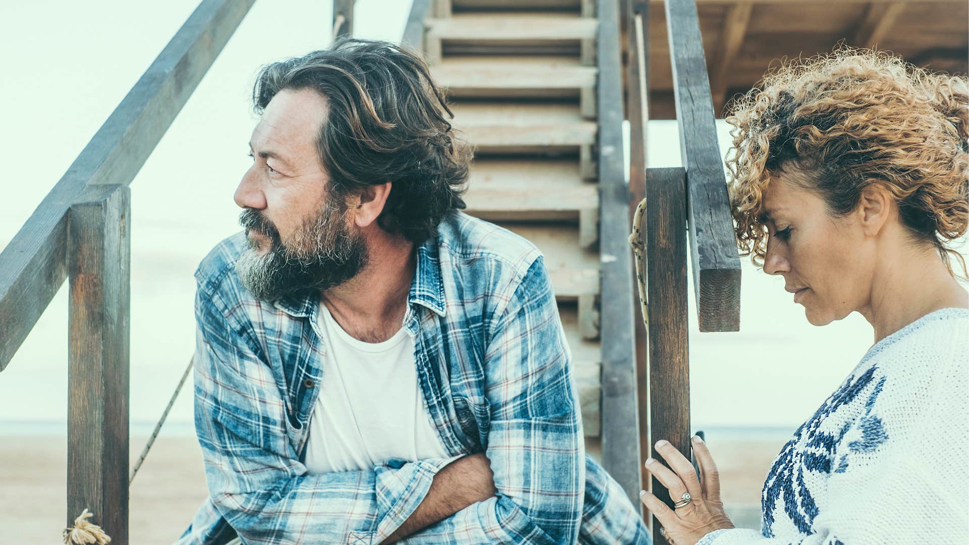 Upset couple look at something else showing not in love anymore