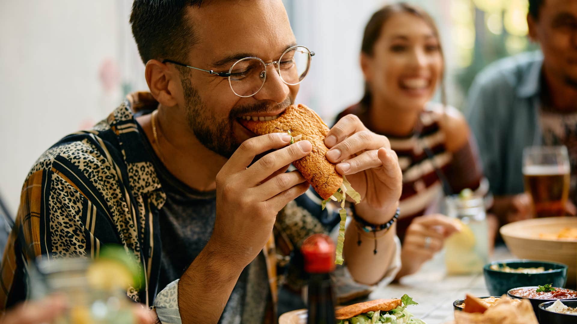 man with access to safe food eating sandwich