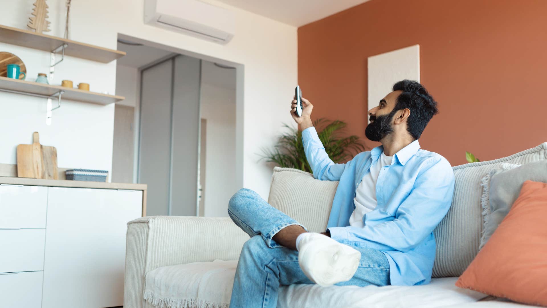 privileged american man turning on central heat and ac