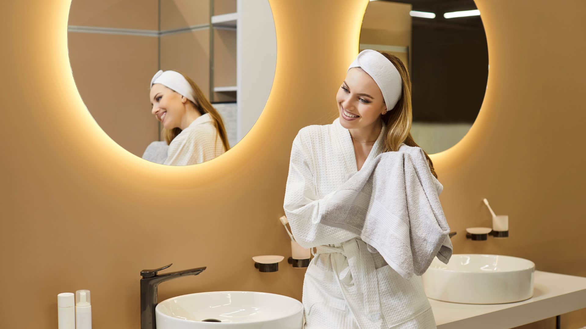 woman drying off with towel in bathroom taking for granted indoor plumbing
