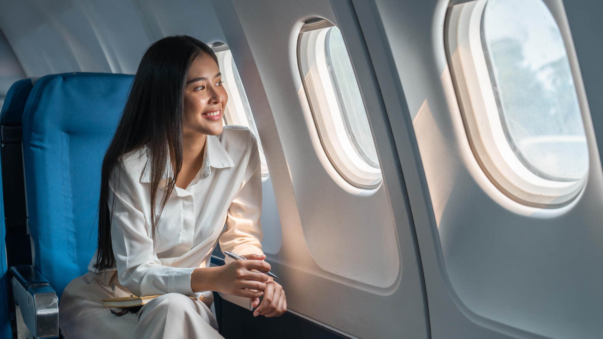 woman with the ability to travel every year sitting on plane