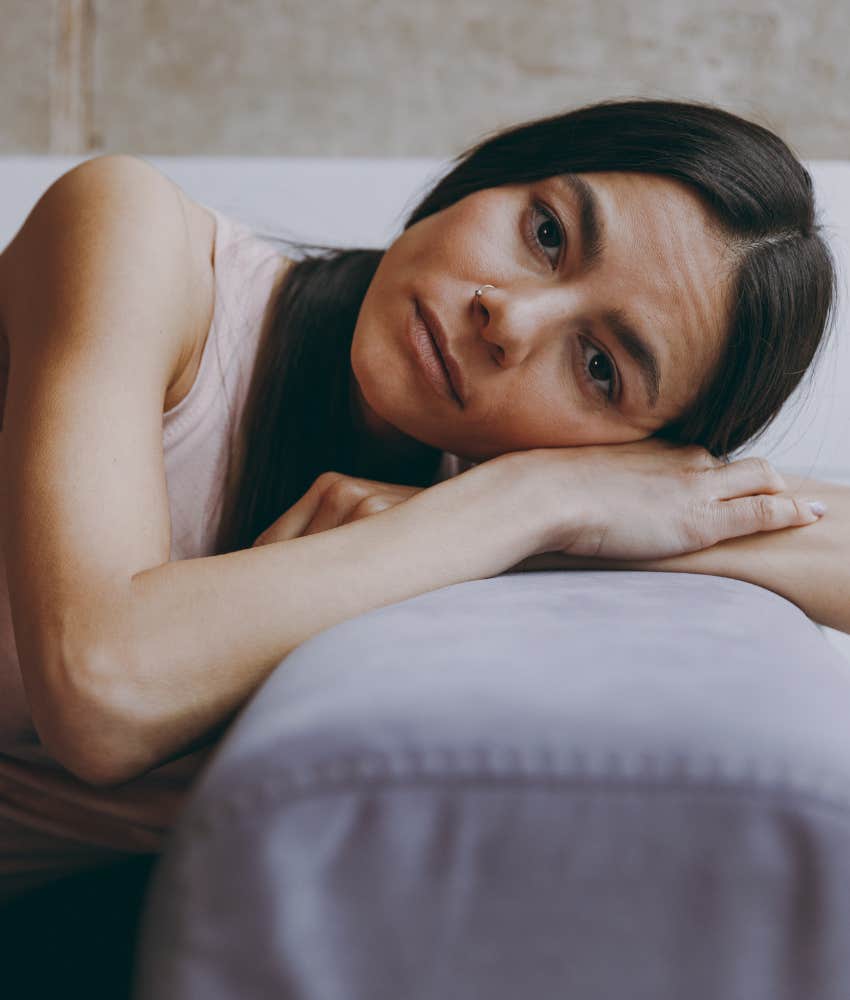 upset person rest head on arms showing conflict avoidance to not change life