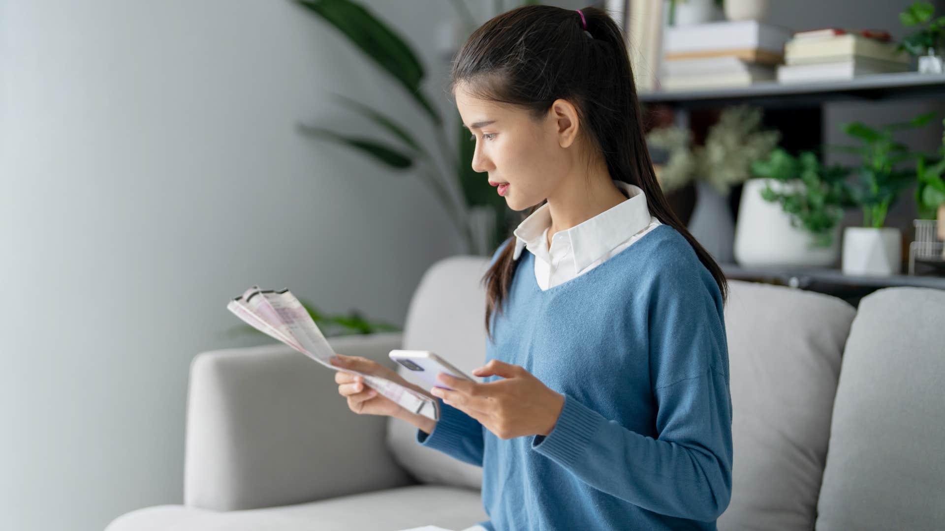 woman in blue sweater still feel financially restrained
