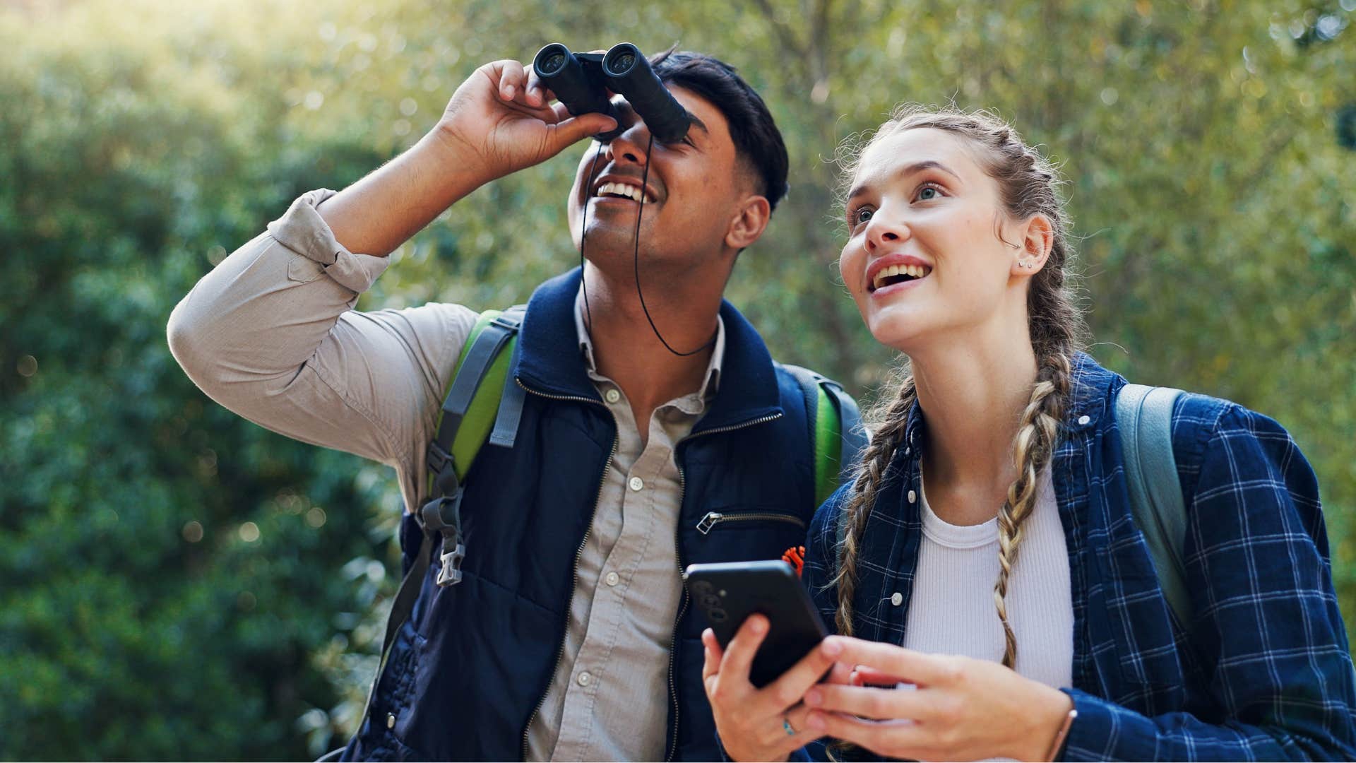 Excited couple bird watching showing growth in relationship