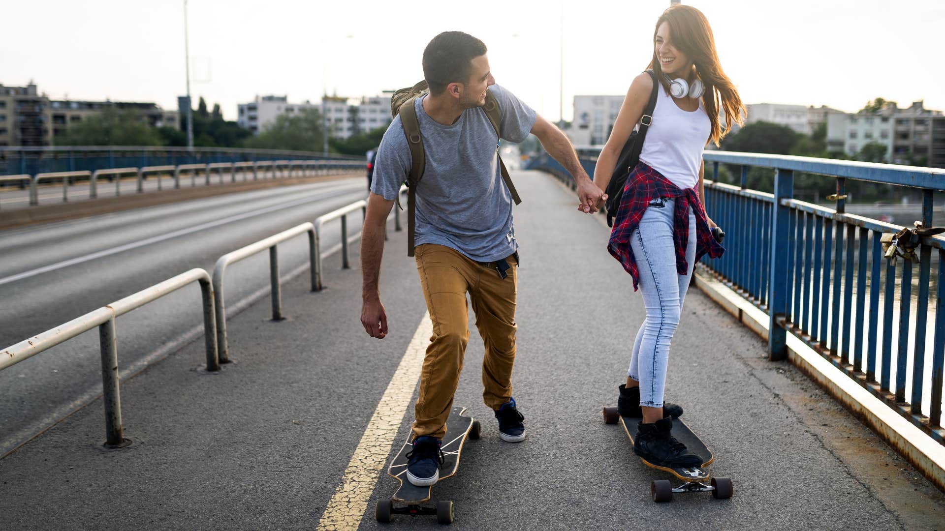 Motivated couple skateboard together showing happy relationship