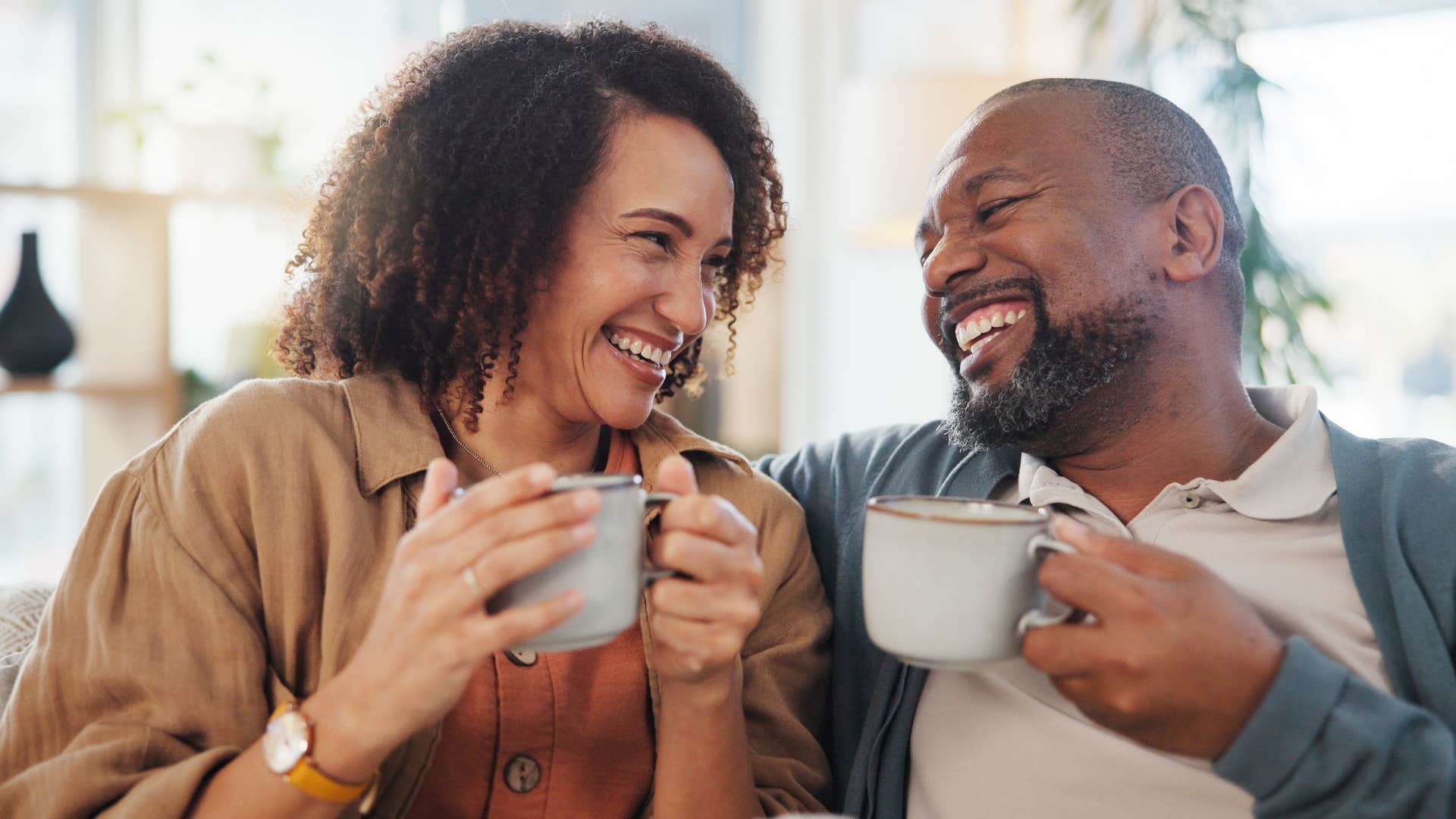 Happy couple laugh together showing supportive relationship