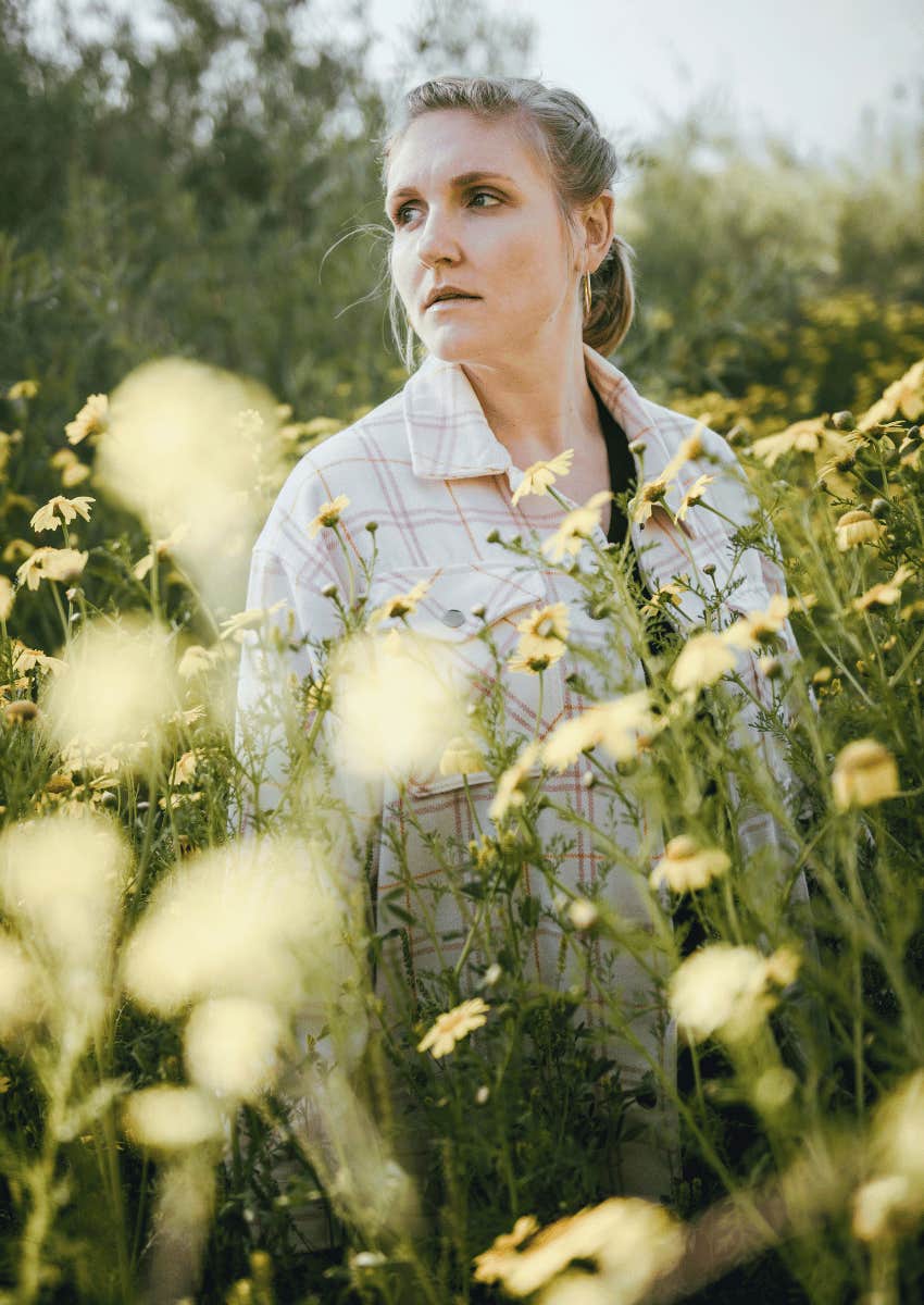 reflective woman standing outside alone