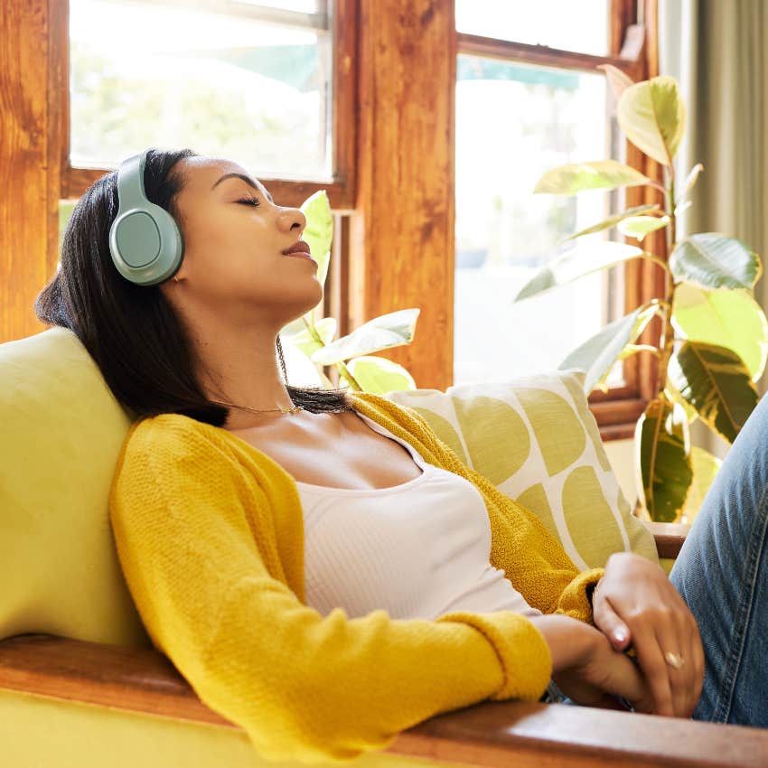 calm woman relaxing and listening to music she loved in high school