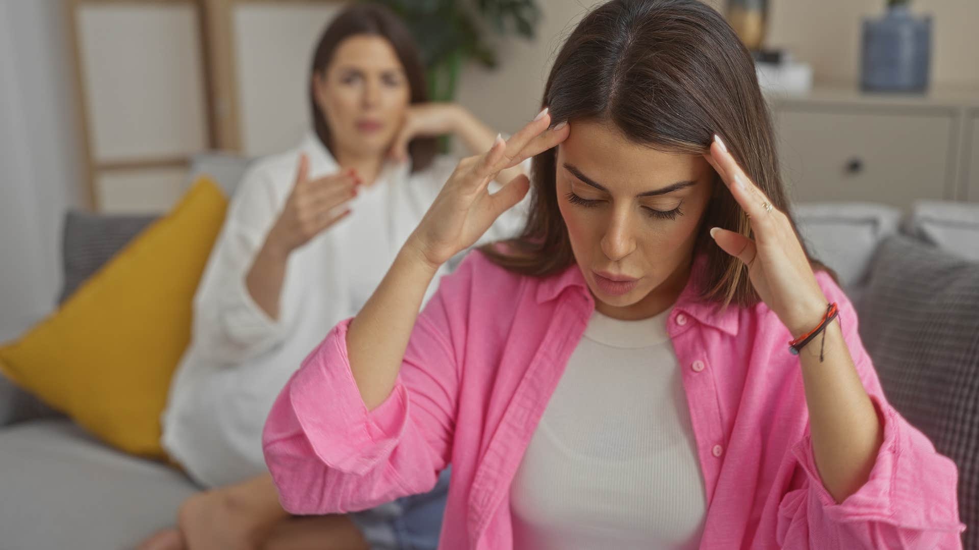 passive-aggressive woman saying I'm sorry you feel that way to annoyed friend