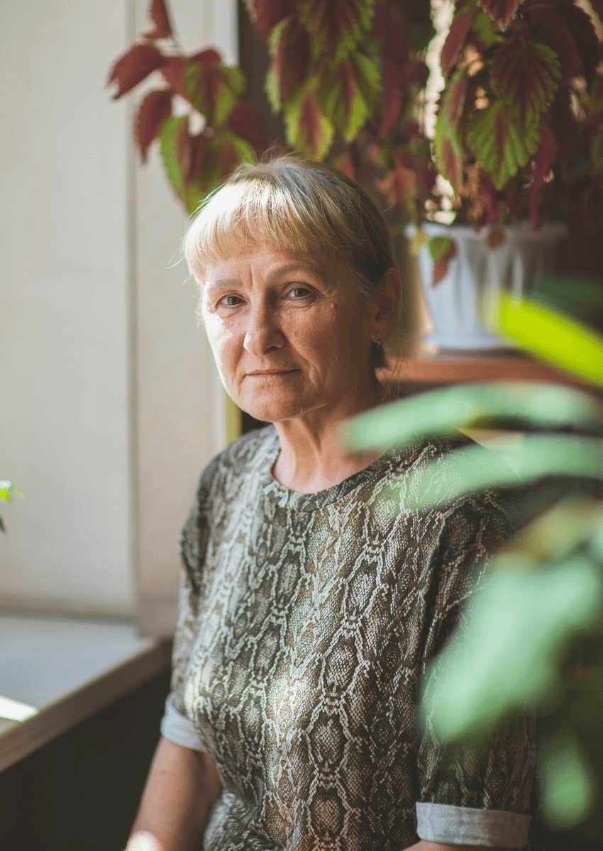 serious older woman sitting alone