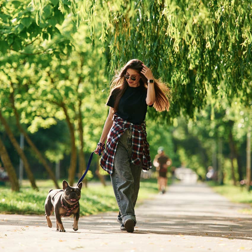 woman walking her dog in the suburbs