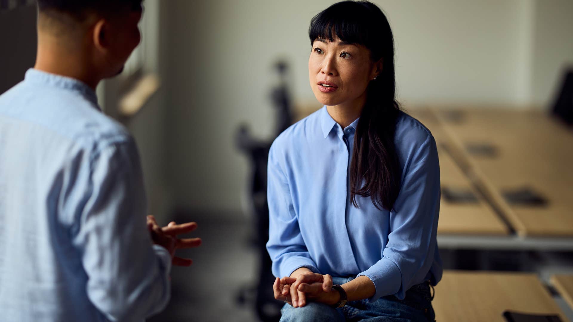 Woman who's okay with being misunderstood talking at work.