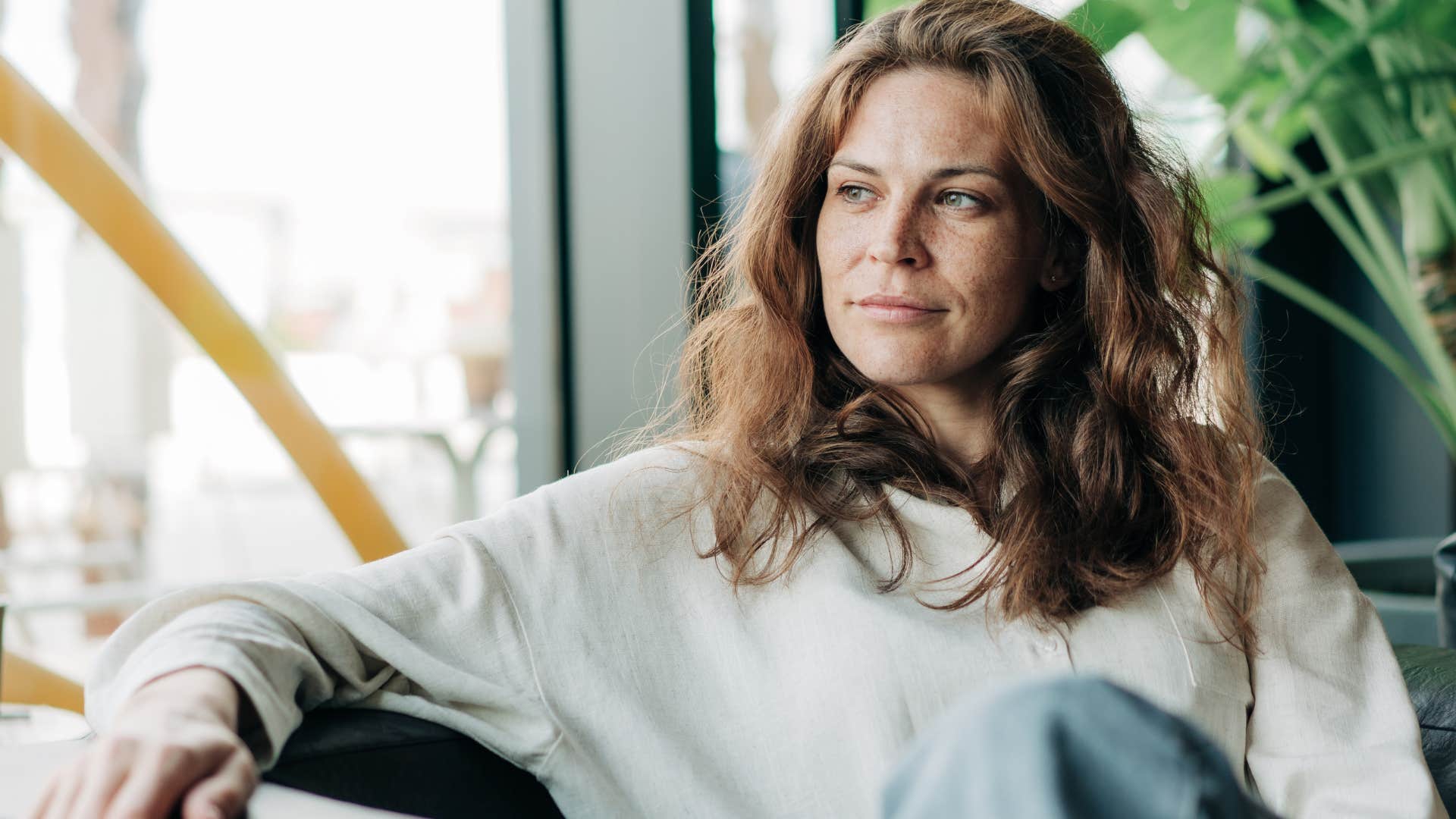 Woman who trusts her intuition sitting at home.