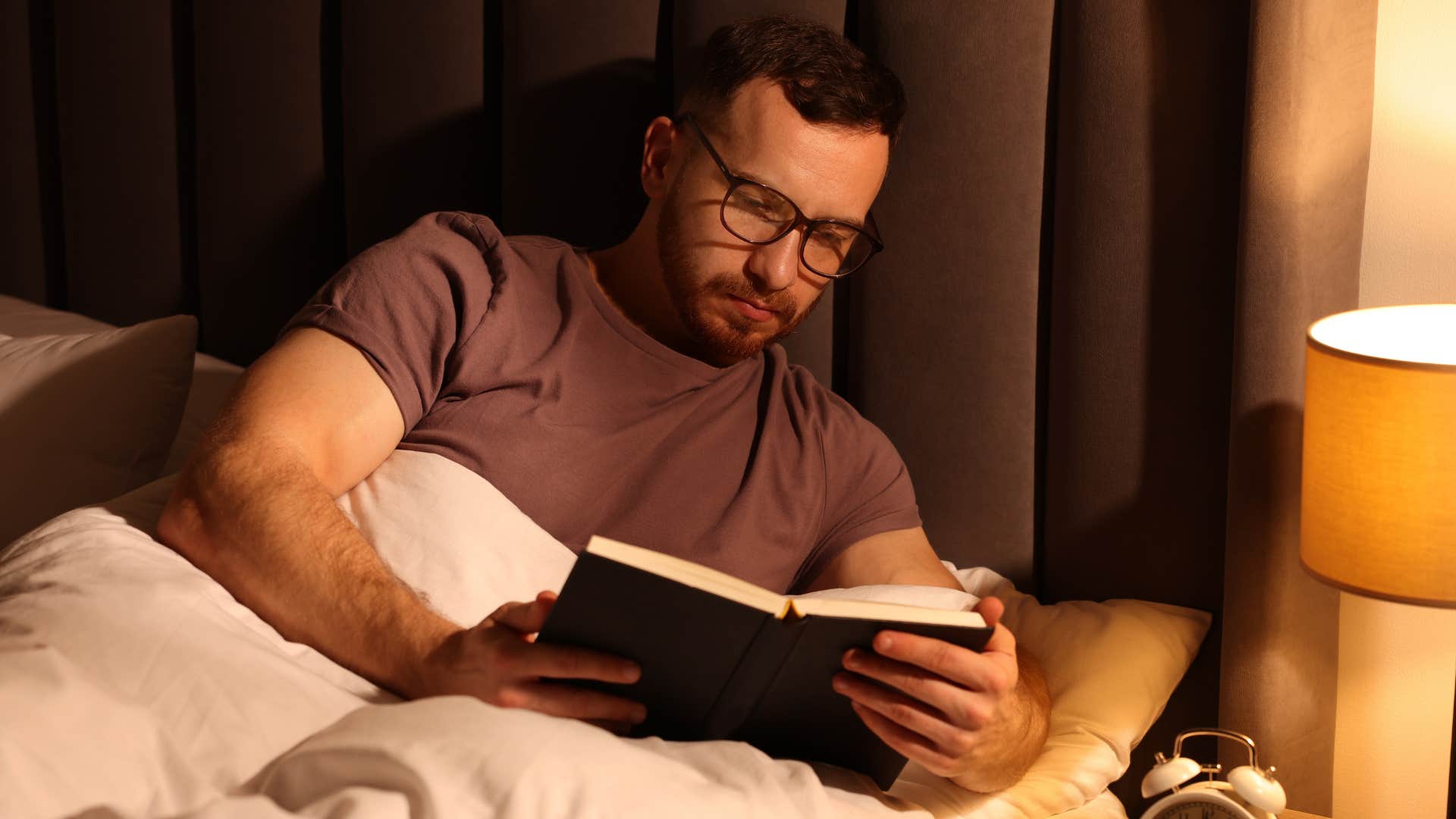 Man who values privacy reading in bed.