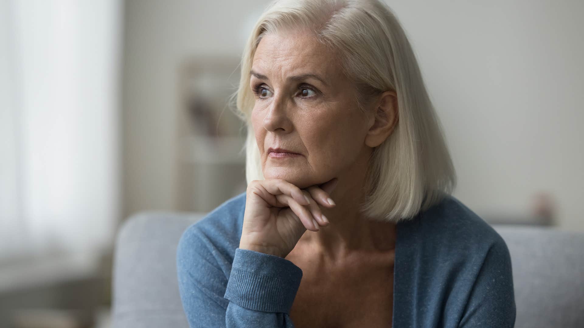 woman who is often labeled pessimistic feeling lonely at home