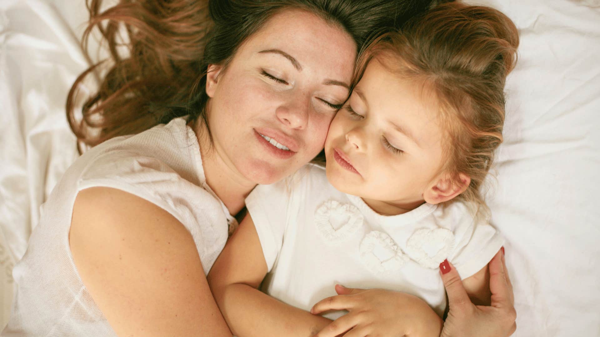 sleeping mother and daughter hugging