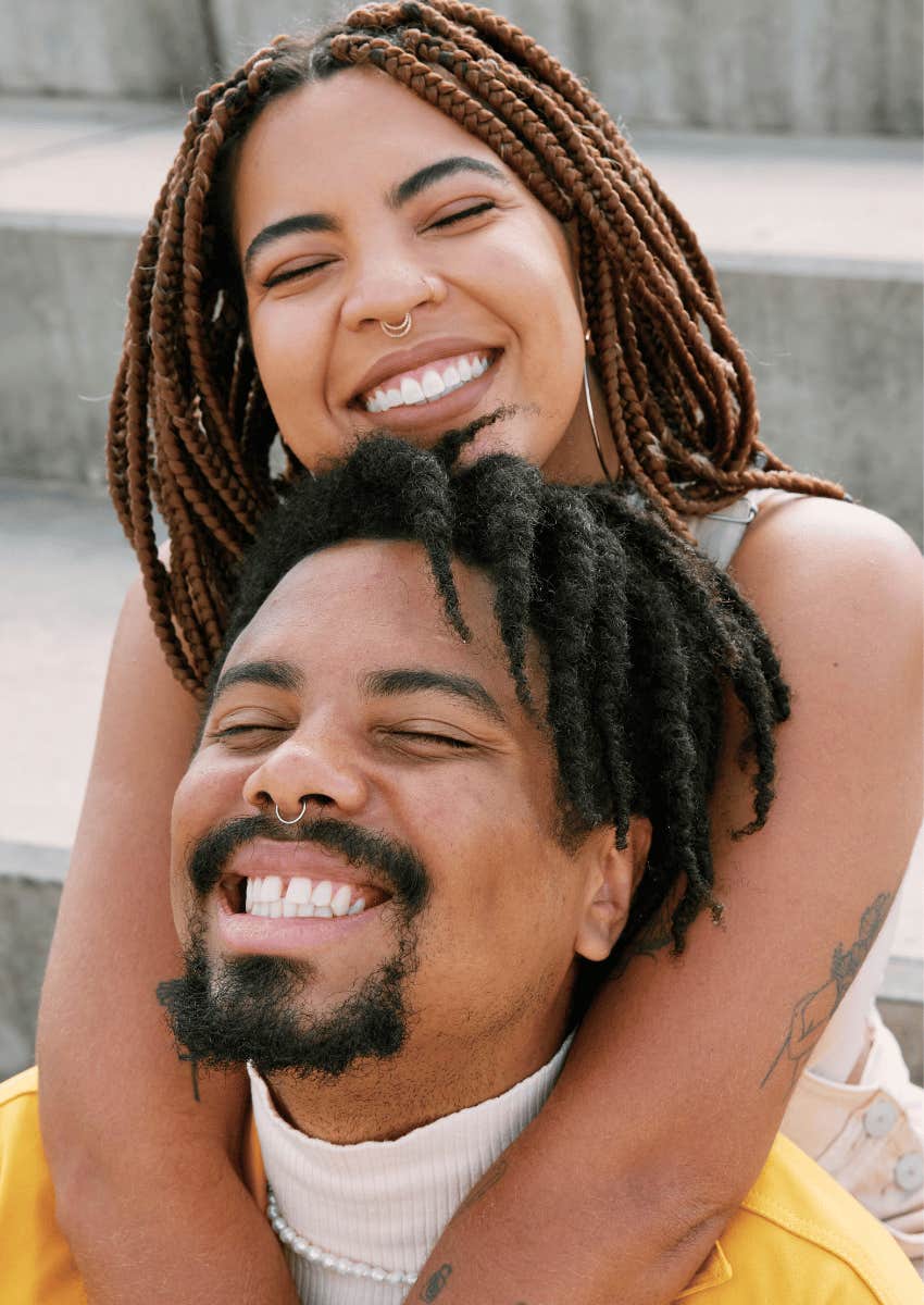 smiling black couple hugging
