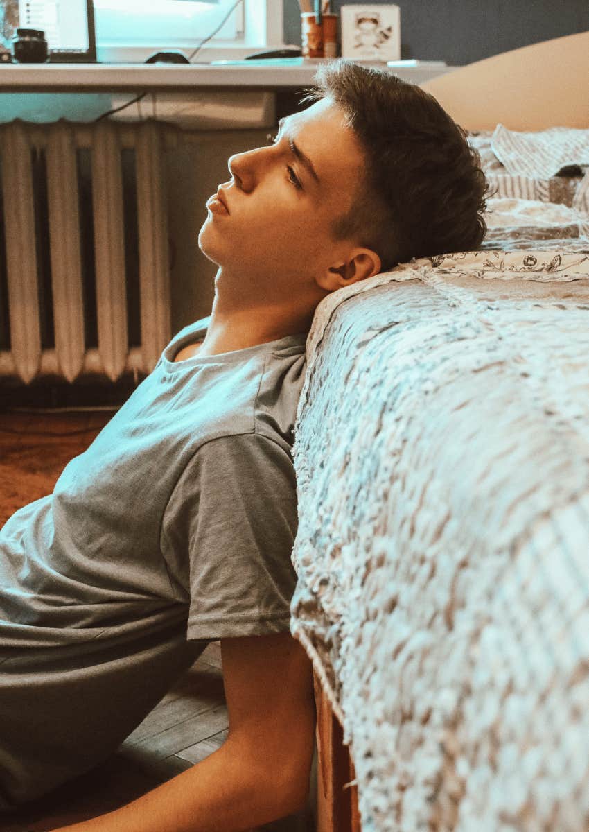 solemn teenage boy in his bedroom