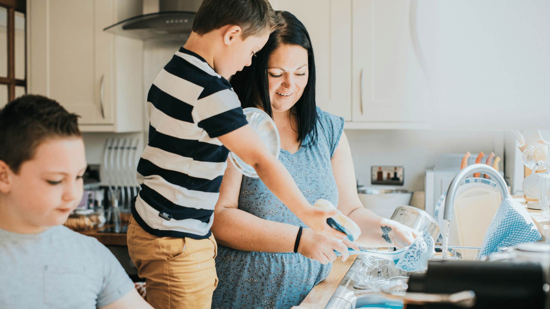 son helping mom do chores together