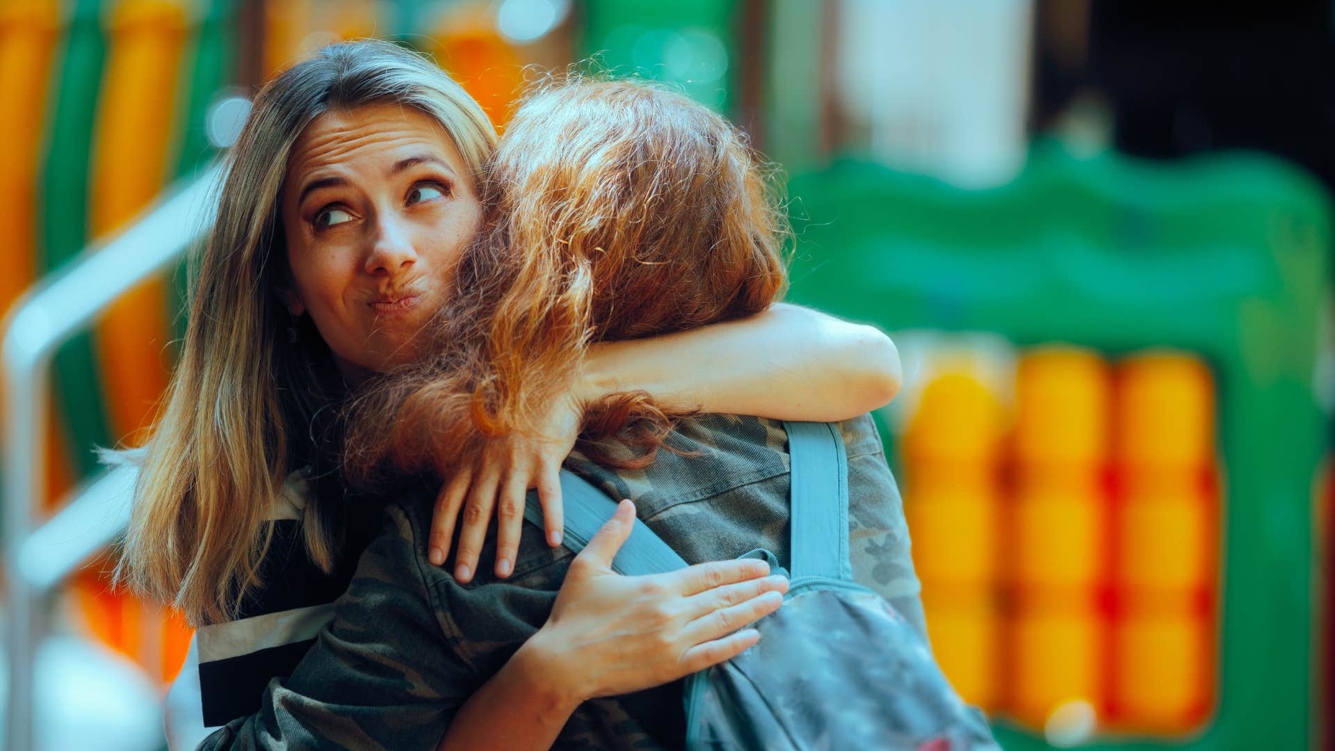 woman hugging friend as her personality changes depending on who's around