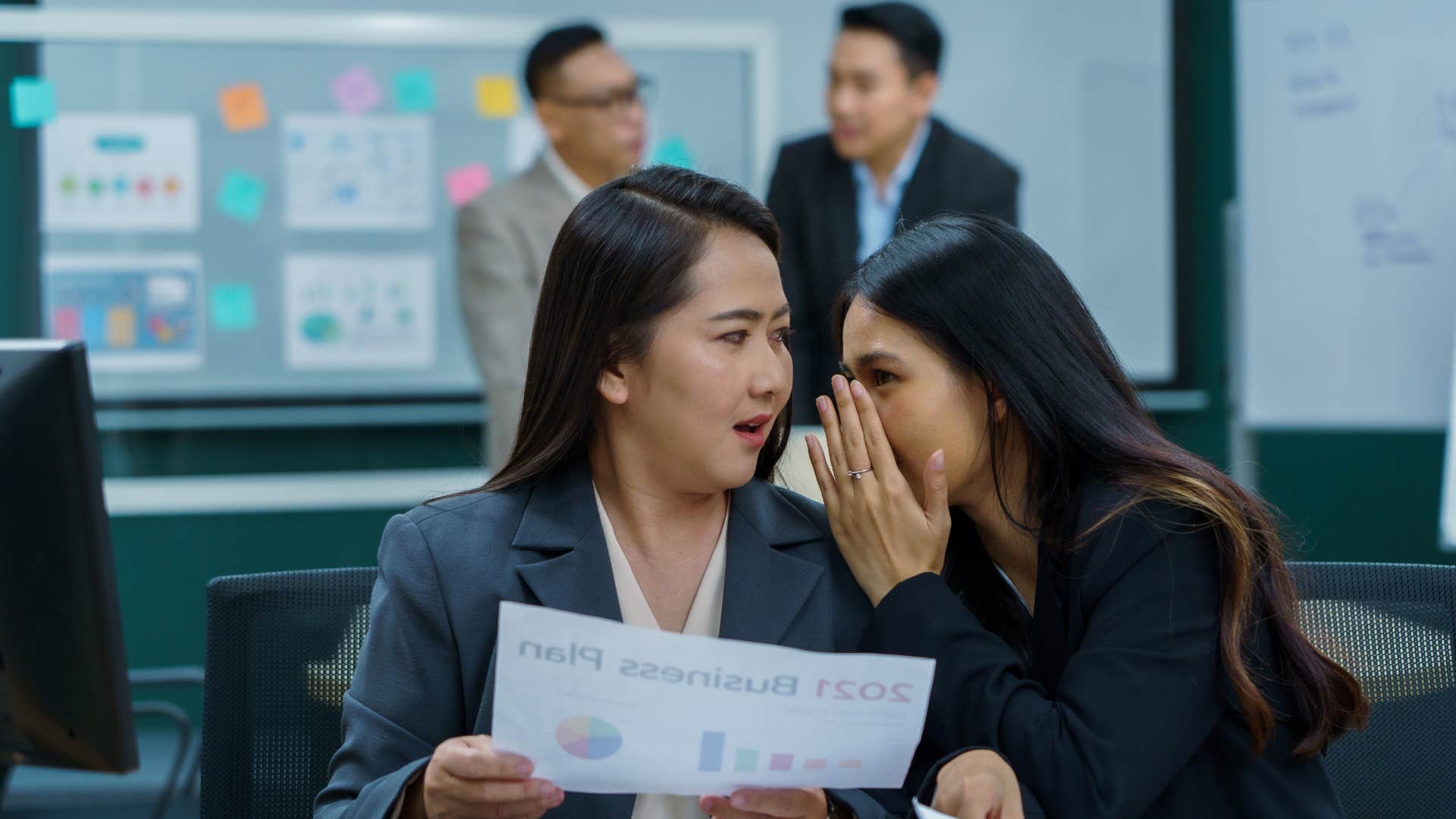 coworkers gossiping as they are subtly negative about others