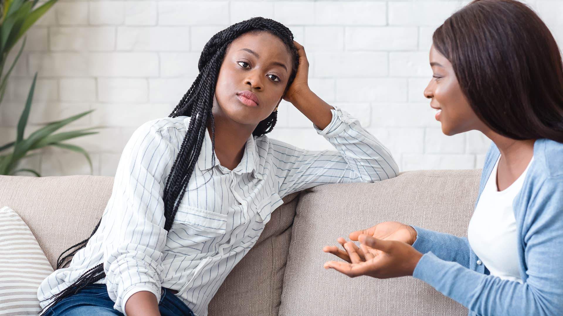 woman in white shirt zoning out as she lacks genuine curiosity about women in blue