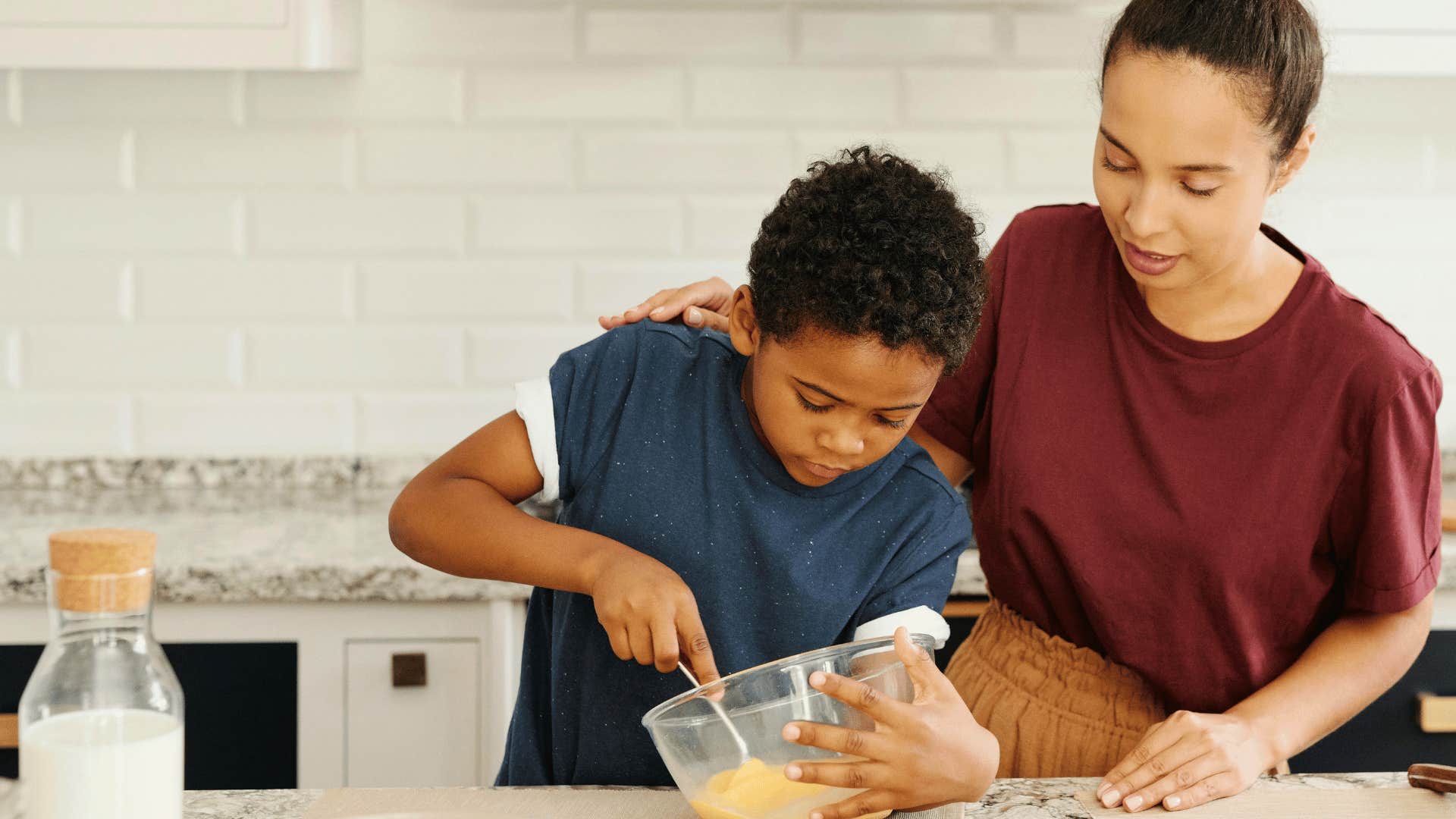 step parent and child cooking together in kitchen for better relationship