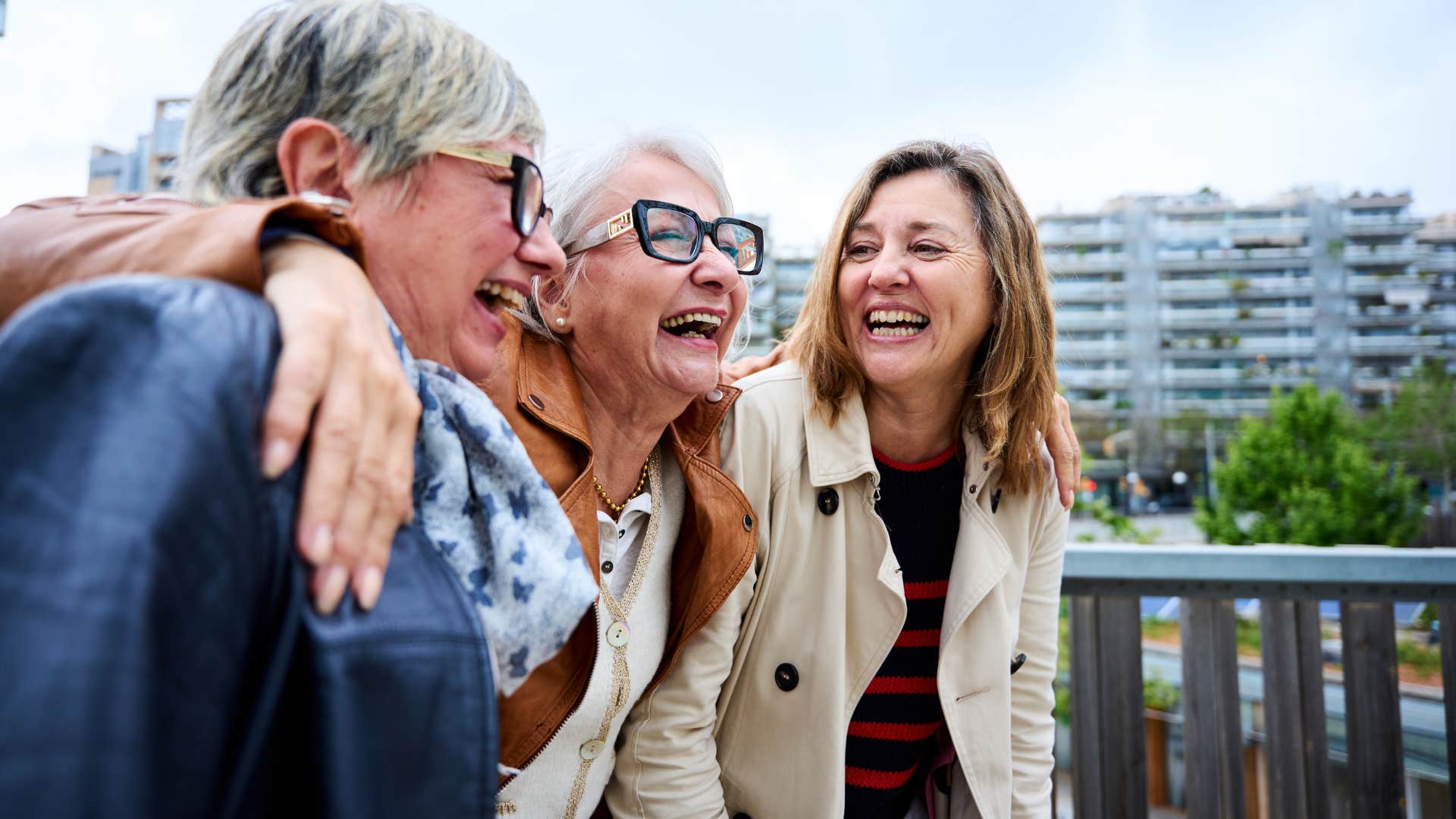 happy group of older people walk arm in arm showing importance friends