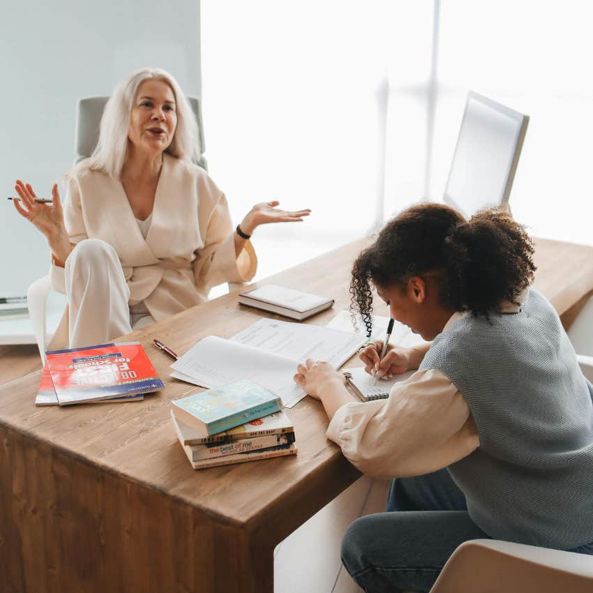 student taking instruction from her teacher