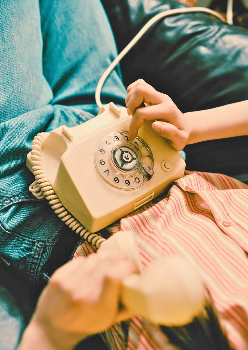 teenager dialing on a rotary phone
