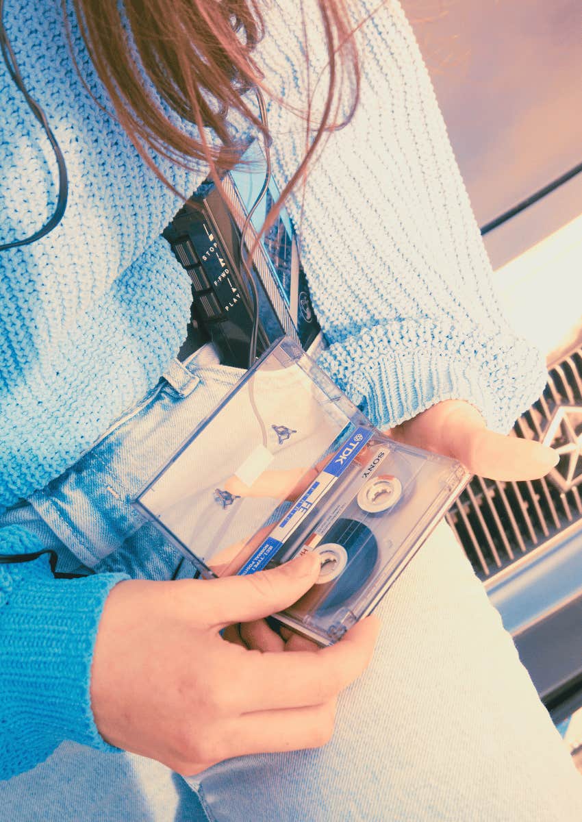teenager pulling out a tape for a walkman