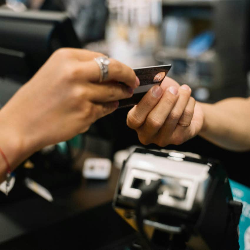 person paying for a purchase with a credit card