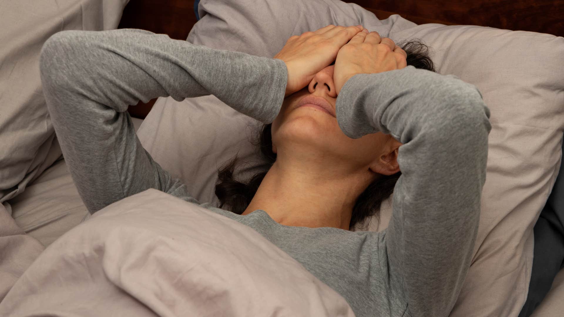 Woman who's hiding from something sitting at home.