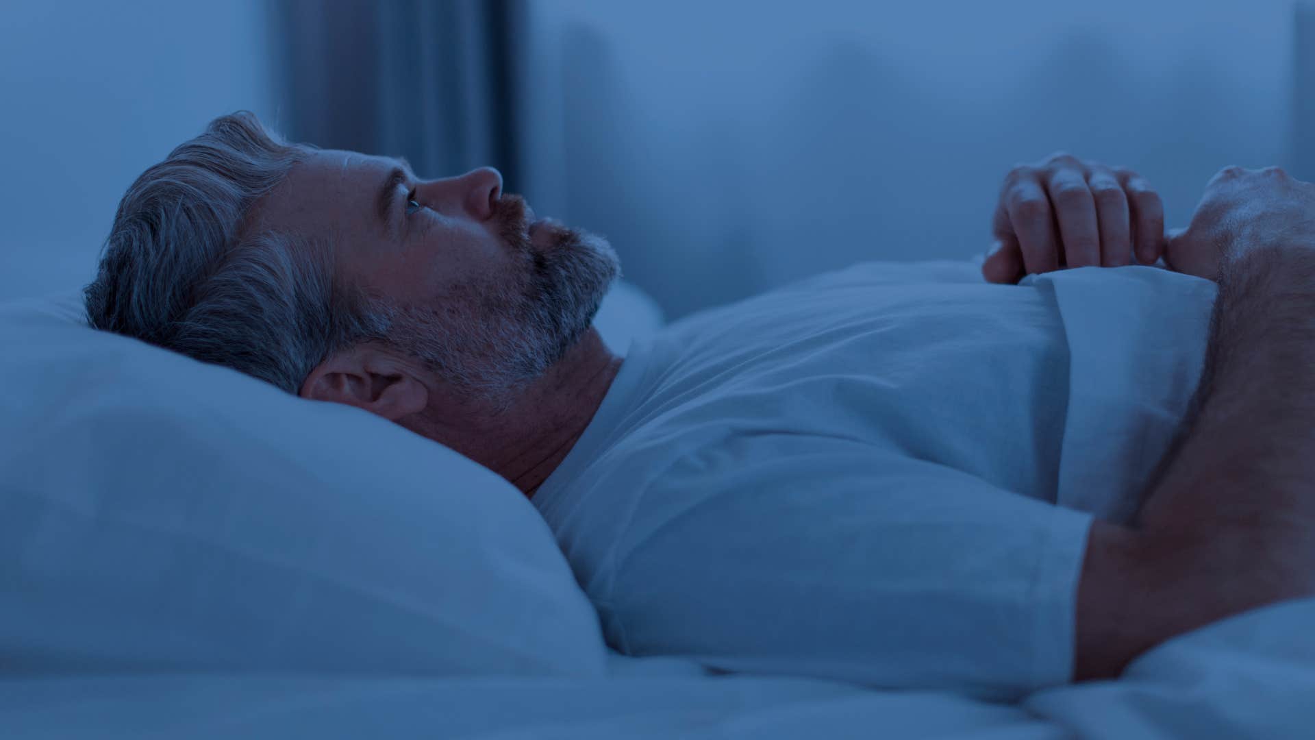 Man who's social and well-connected sleeping at home.