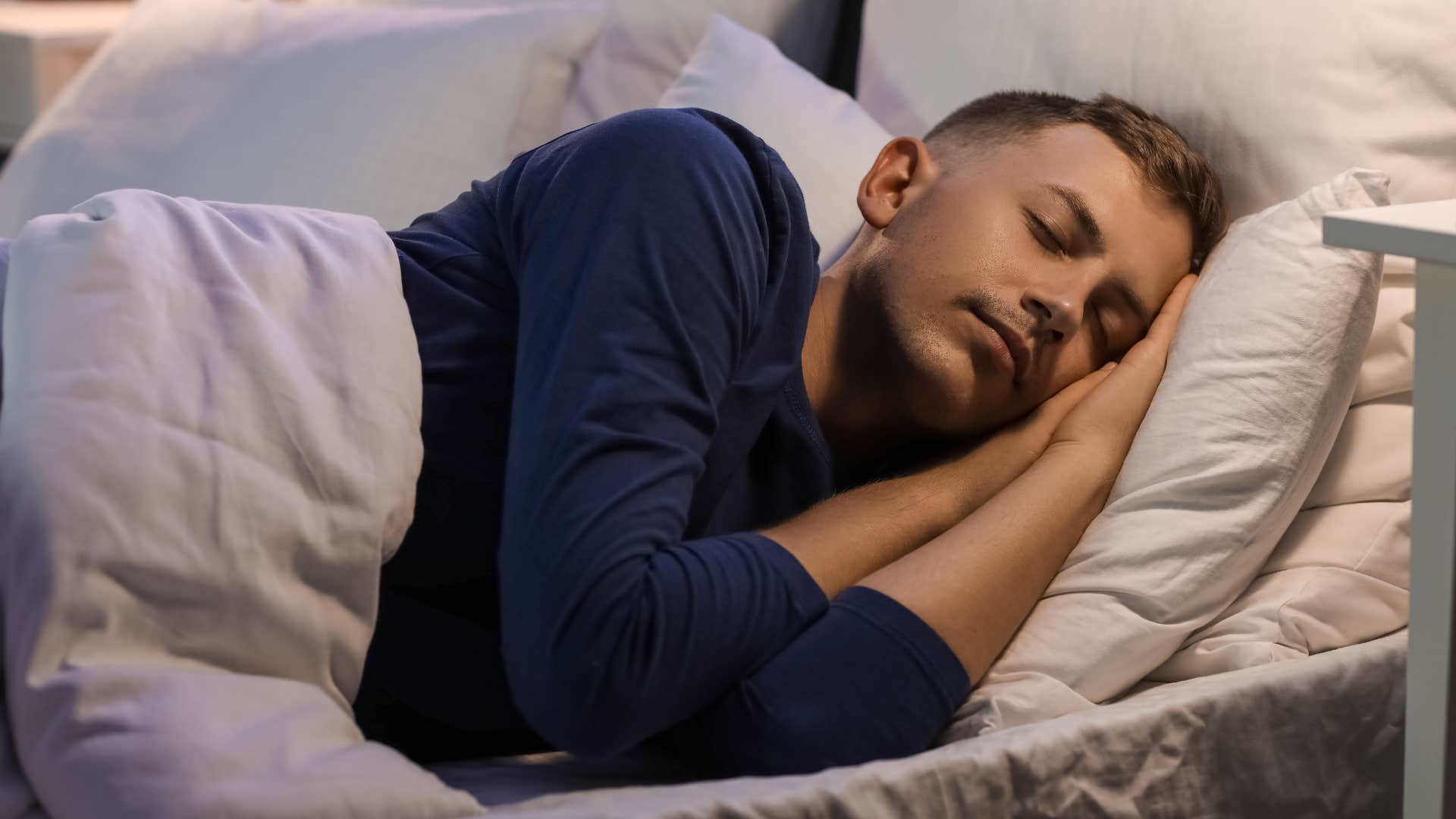 Man who struggles to open up to people sleeping in bed.