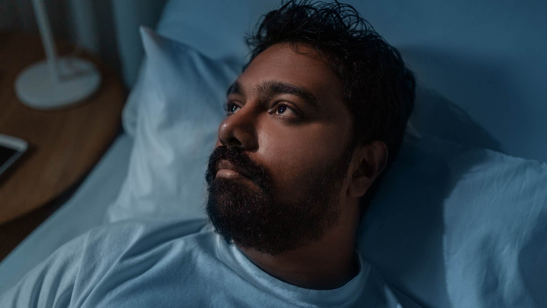 Quiet and introverted man sleeping in bed.