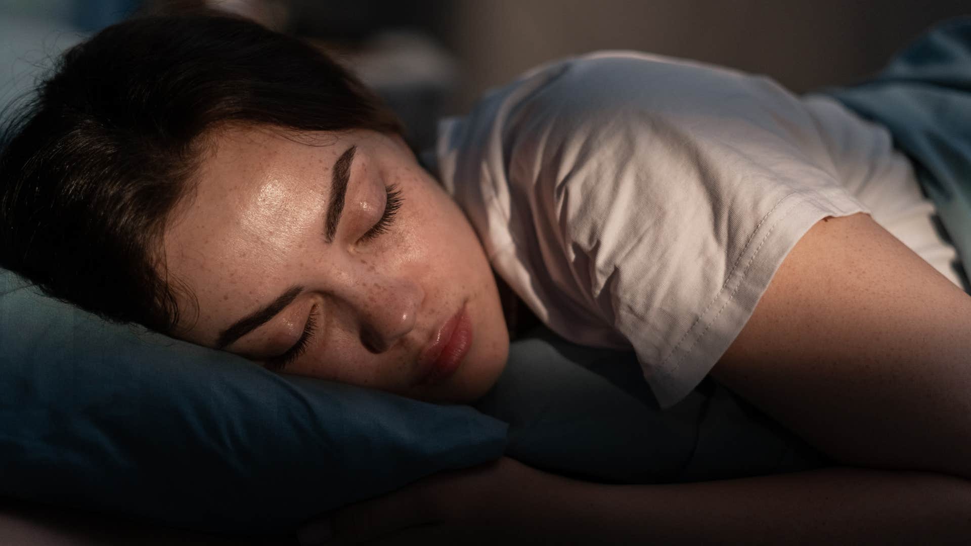 Woman who's too stressed sleeping in bed.