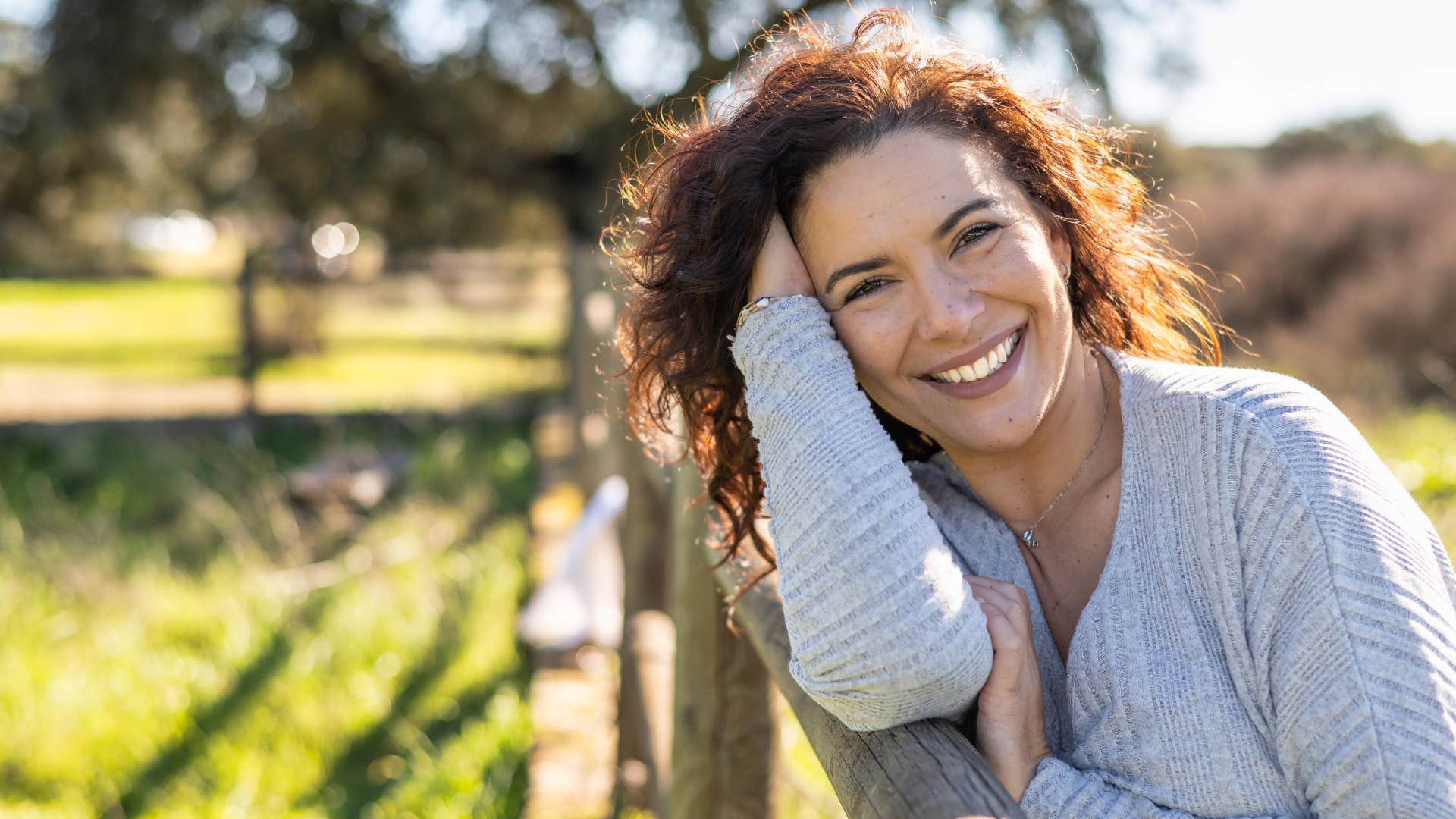 annoying woman smiling while saying everything happens for a reason