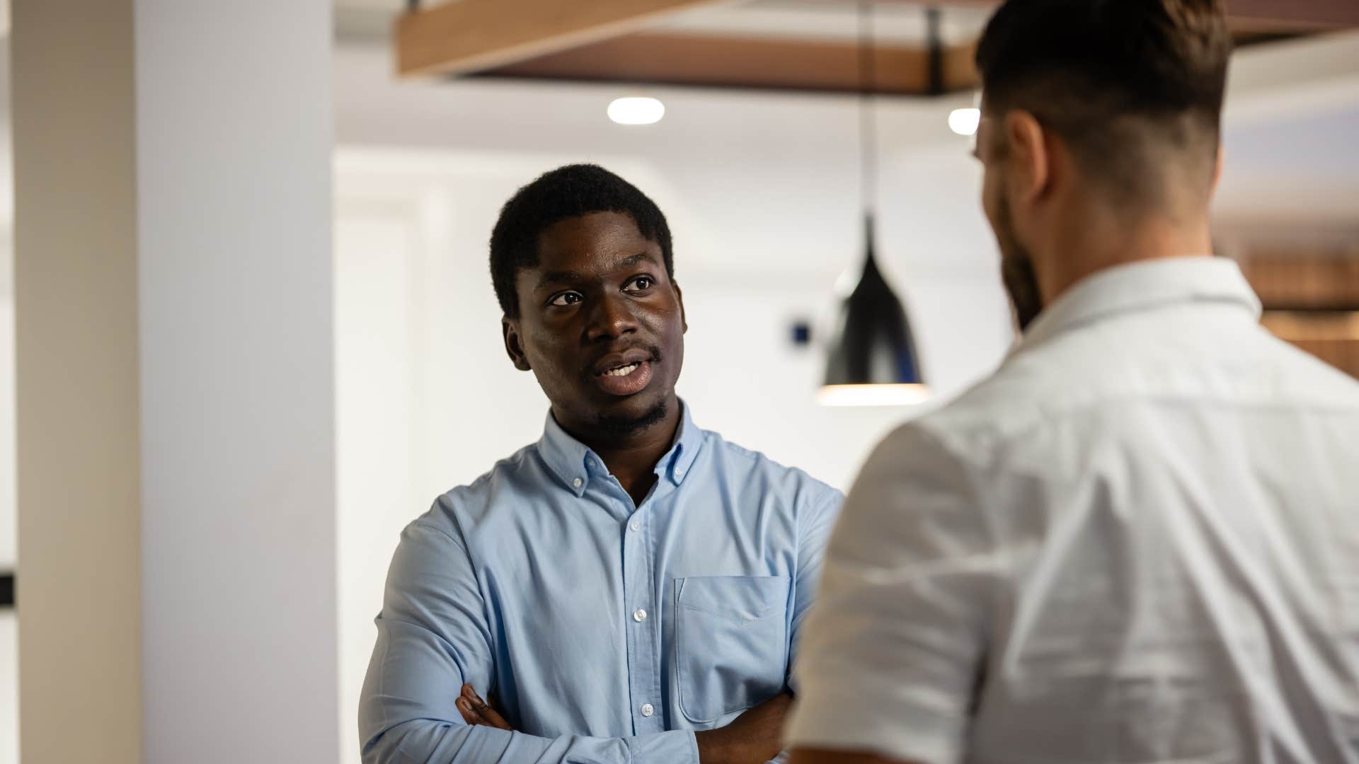 man annoyed at co-worker saying no offense but