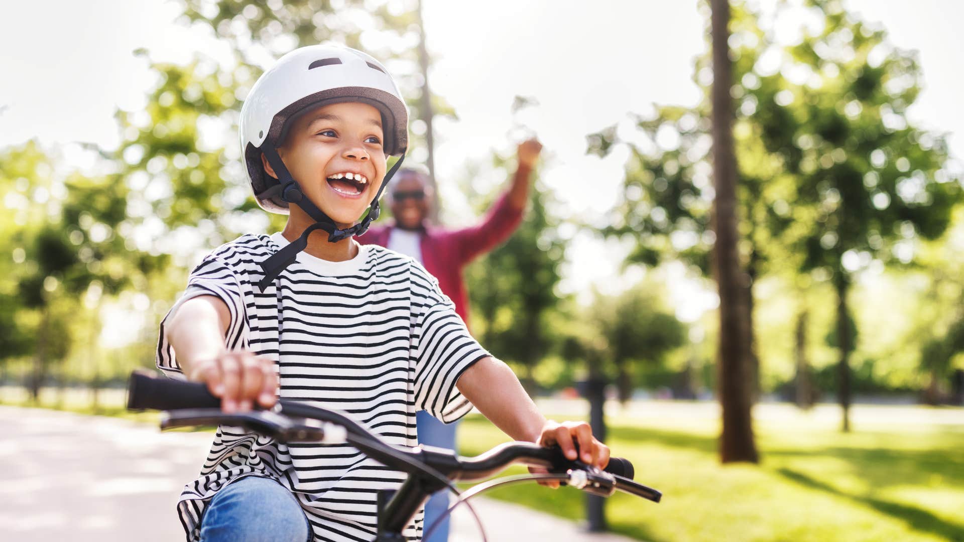 little boy riding bike on street after school